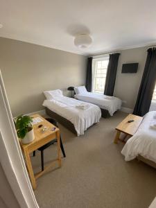 A bed or beds in a room at The Central Guesthouse