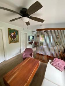 a living room with a table and a ceiling fan at La Calma - Chatham Grove, Unit 2 in Montego Bay