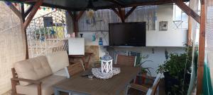 a living room with a couch and a table and a television at Casa Afonso in Lagos