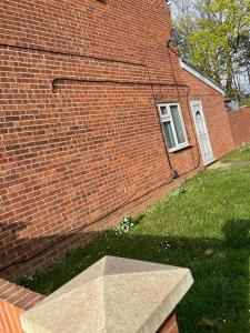 a brick building with a window on the side of it at Travel Legend Stays 1 or 2 bedroom place with Hot Tub in Farnham Royal