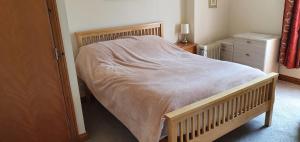 a bedroom with a bed with a blanket on it at Victoria Farm in Lutterworth