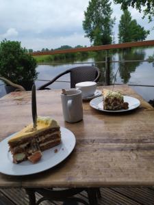 a table with a slice of cake on a table at Gästehaus Hölting in Lübberstedt