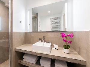 a bathroom with a sink and a mirror at LivinParis - Luxury 2 Bedrooms Centre Pompidou in Paris