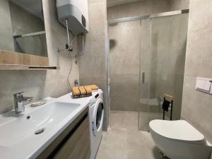 a bathroom with a sink and a toilet and a shower at Lasadu Studio in Casa Al Mare, 2 min to Beach in Bečići +38 photos