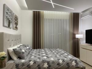 a bedroom with a bed and a television at Lasadu Studio in Casa Al Mare, 2 min to Beach in Bečići