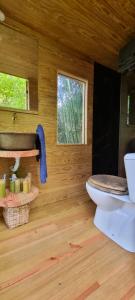 a bathroom with a toilet and a wooden wall at Ribeira Delos in Santa Marta de Penaguião