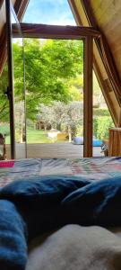 a bed in a room with a large window at Ribeira Delos in Santa Marta de Penaguião