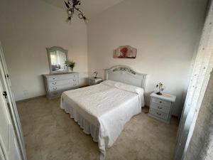 A bed or beds in a room at Masseria Paglieroni