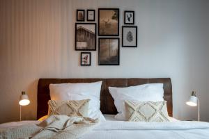 a bedroom with a bed with framed pictures on the wall at TREEHOUSE - KiDS PARADISE - CENTRAL - SSC in Winterberg