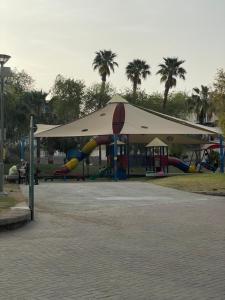 a park with a play area with a tent at דירה יפה ומרווחת במרכז העיר in Eilat