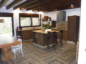 a kitchen with a island in the middle of a room at La Gurriata de La Vera in Villanueva de la Vera