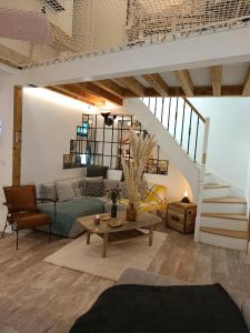 a living room with a couch and a table at Le Maréchal Duplex - Appartement avec Jacuzzi - CAEN hyper Centre in Caen