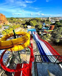 a roller coaster at a theme park with a slide at CD PIAZZA COM ACQUA PARK in Caldas Novas