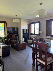 a living room with a couch and a table at Casa frente a los Bufones de Pria in Llames de Pría