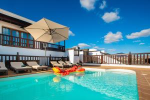 basen z nadmuchiwaną tratwą w wodzie w obiekcie Villa Vista Rey - 6 Bedroom - Heated Pool - Amazing Views - Pool Table - Vista Lobos - Playa Blanca w mieście Playa Blanca