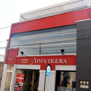 a store with a red sign on the front of a building at Hotel del Arte y Figura in León