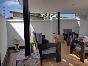 a living room with a couch and a table at Mkamiti Villa - Airport Hotel Dar Es Salaam in Dar es Salaam
