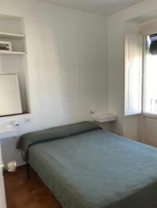 a bedroom with a bed in a white room at Apartamento Luminoso y Acogedor Port de la Selva in Port de la Selva