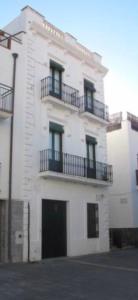 a white building with balconies on the side of it at Apartamento Luminoso y Acogedor Port de la Selva in Port de la Selva