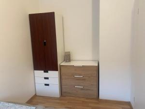 a bedroom with a dresser and a tall cabinet at Grønnegade - tæt på centrum in Esbjerg +3 photos
