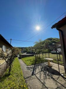 a view from the backyard of a house with a picnic table at Apartman Magdalena in Banja Koviljača