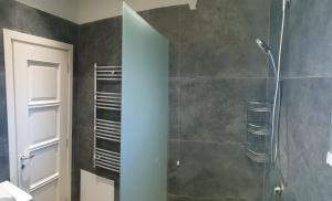 a bathroom with a shower with a glass door at HILLTOP HIDEAWAY in Elbasan +20 photos