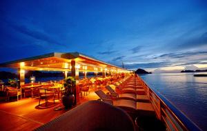 a deck of a cruise ship with tables and chairs at Golden Cruise in Ha Long
