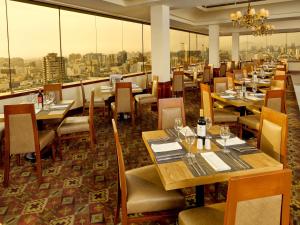 
a restaurant with tables, chairs, and tables in it at Hotel Estelar Miraflores in Lima

