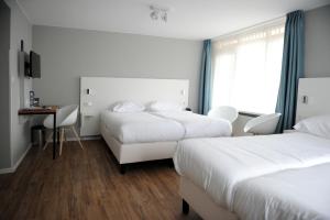 Ein Bett oder Betten in einem Zimmer der Unterkunft Hotel Andante aan Zee