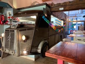 an old food truck with a bench in a restaurant at Antwerp City Hostel in Antwerp