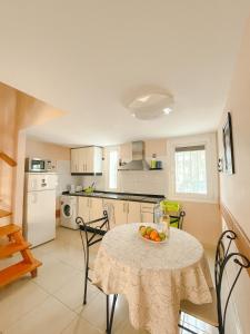 a kitchen with a table with a bowl of fruit on it at Cortijo in Playa de las Americas