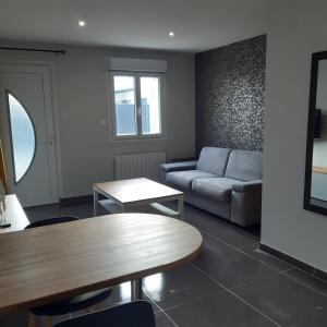 a living room with a couch and a table at LE STUDIO DE FLAVIA in Alençon