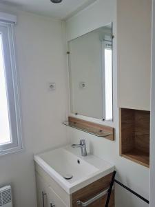 a bathroom with a sink and a mirror at Hebergement dans un Domaine à Litteau in Litteau +33 photos