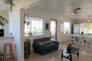 a living room with a couch and a table at Casa com Vista Panorâmica da Praia de Pontal do PR in Balneário Praia do Leste