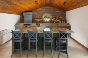 a kitchen with a large island with bar stools at Molino Hotel in Kaş