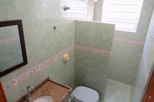 a bathroom with a toilet and a sink at Casa com Vista Panorâmica da Praia de Pontal do PR in Balneário Praia do Leste +54 photos