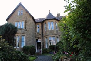 a large brick house with a driveway at Aydon House in Alnwick