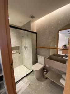 a bathroom with a shower and a toilet and a sink at Salinas Premium Resort in Salinópolis
