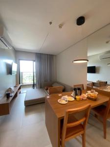 a dining room and living room with a table and chairs at Salinas Premium Resort in Salinópolis