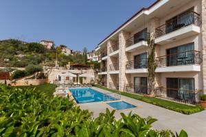 an apartment building with a swimming pool at Molino Hotel in Kaş