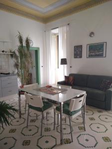 a living room with a table and chairs and a couch at Maddalena House in Spello