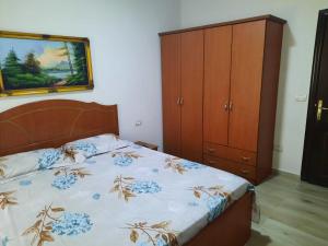a bedroom with a bed and a wooden cabinet at Pine Apartment 2 plus 1 in Golem