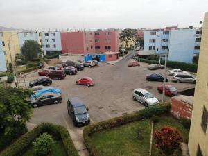 a parking lot with cars parked in it at Jacky's Home Santa Rosa in Lima