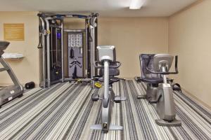 a gym with two exercise bikes and tread machines at Sonesta Simply Suites Orange County Airport in Santa Ana