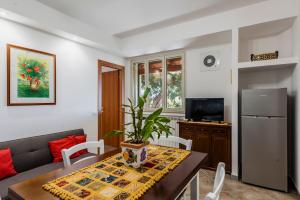 a living room with a table with a plant on it at Valleforno Country House di Charme in Ispica