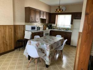 a kitchen with a table and chairs and a refrigerator at Cute and cozy at Niagara Falls USA in Niagara Falls +9 photos