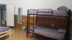 a room with two bunk beds and a mirror at Casa Hostal Luna Llena in Cartagena de Indias