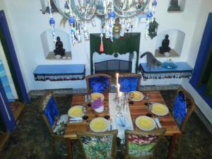 a dining room with a table and chairs with a candle at Cemil İpekçi Pension in Bodrum City
