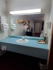 a bathroom with a sink and a mirror at Spinning Wheel Inn in Branson