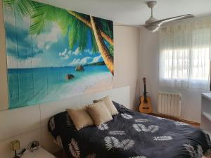 a bedroom with a palm tree painting on the wall at Apartamento Almenara Nova Almenareta in Almenara